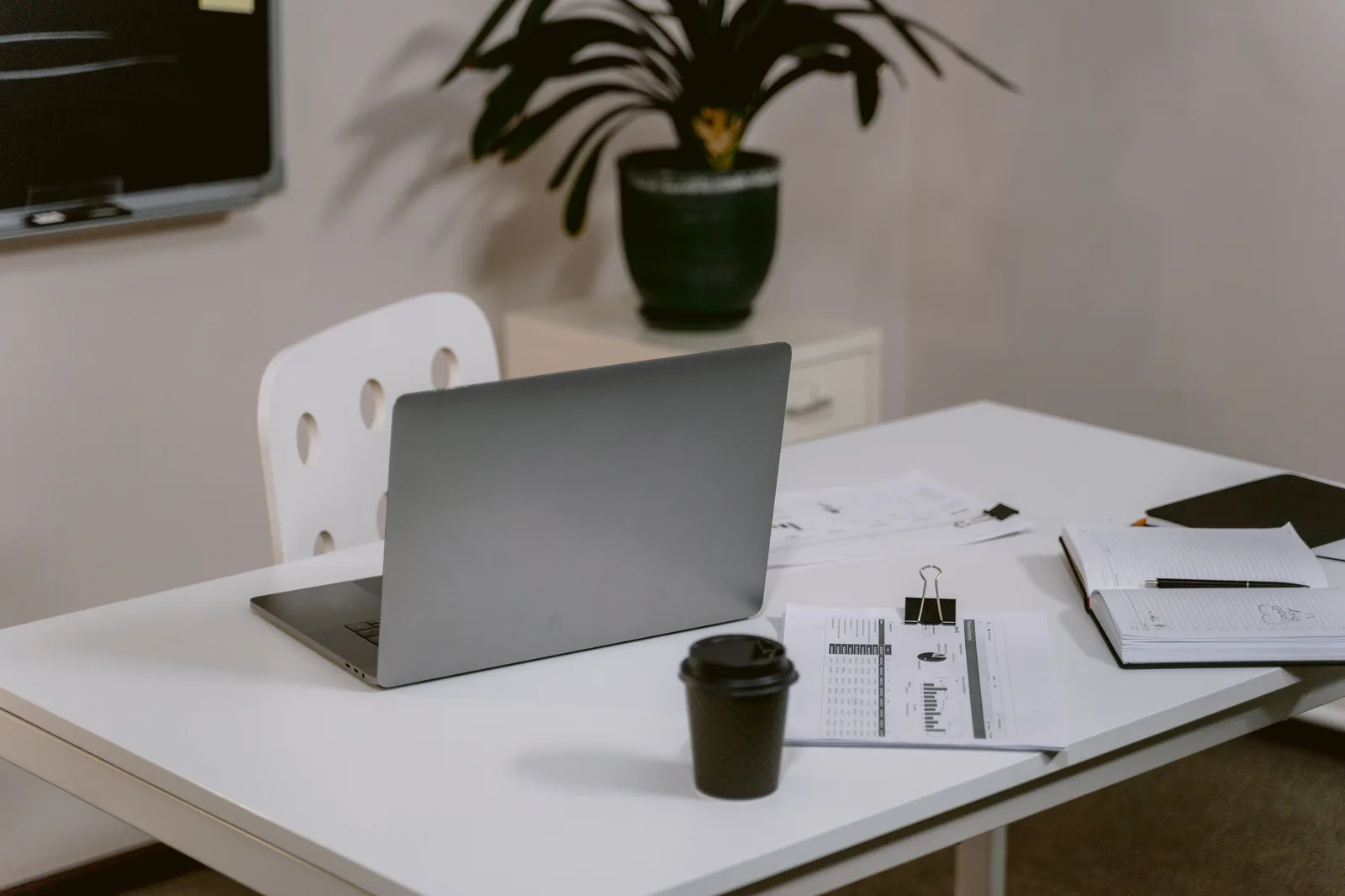 A clean and organized office desk with a laptop and business documents, ideal for productivity. Which markets suit a translation agency business for 2027