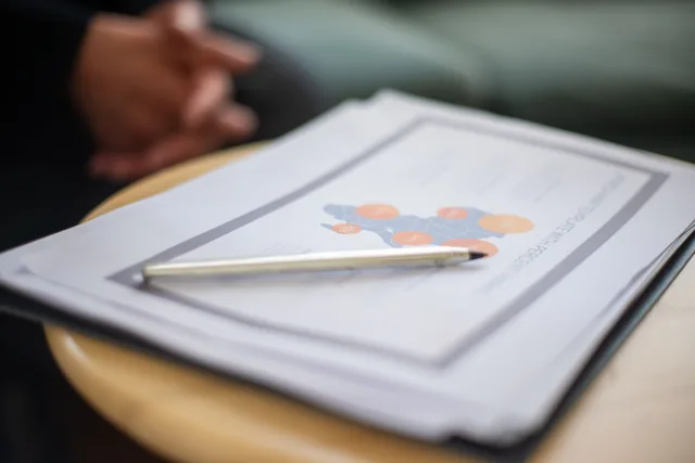 Close-up of business document and pen on a round table, perfect for office and corporate themes. Emergency Language Access Plan for US Counties and Translation Agencies