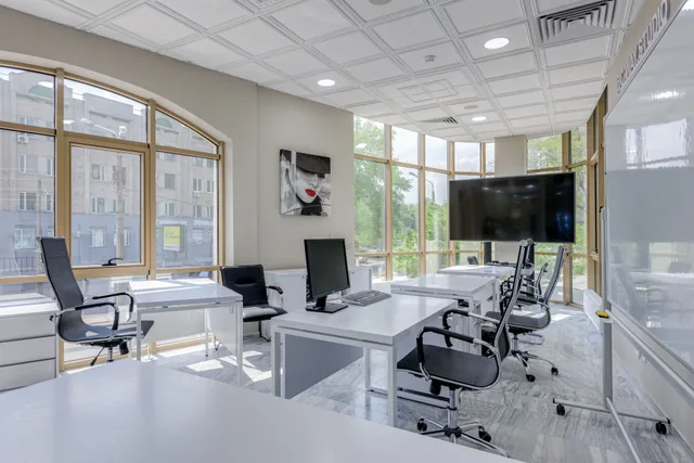Contemporary minimalist office with glass windows and ergonomic chairs. Translation Agency Client Retention: Metrics and Risks
