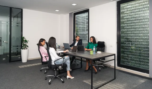 A professional team engaged in a meeting in a modern office setting in Georgia. The break-even point for a translation agency, and how to reach it sooner